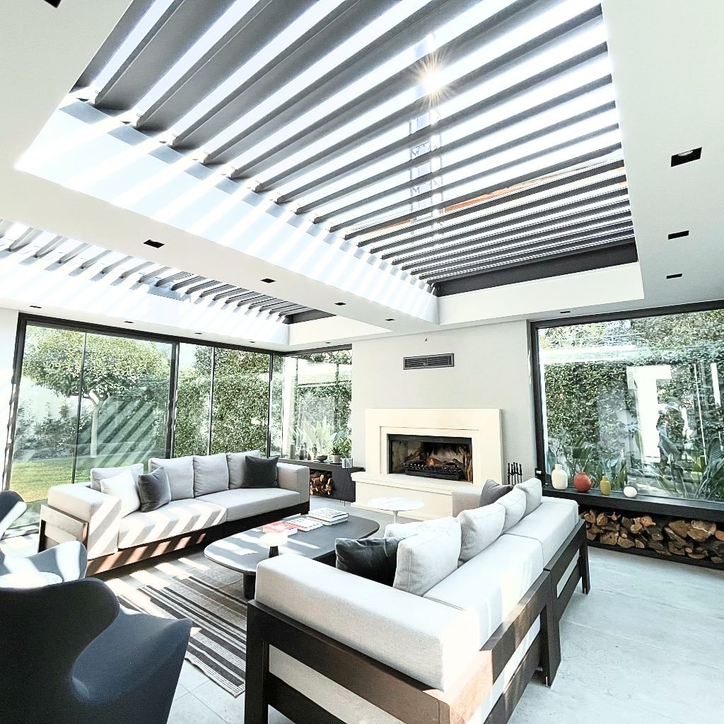 Motorized louvered pergola over a residential courtyard lounge