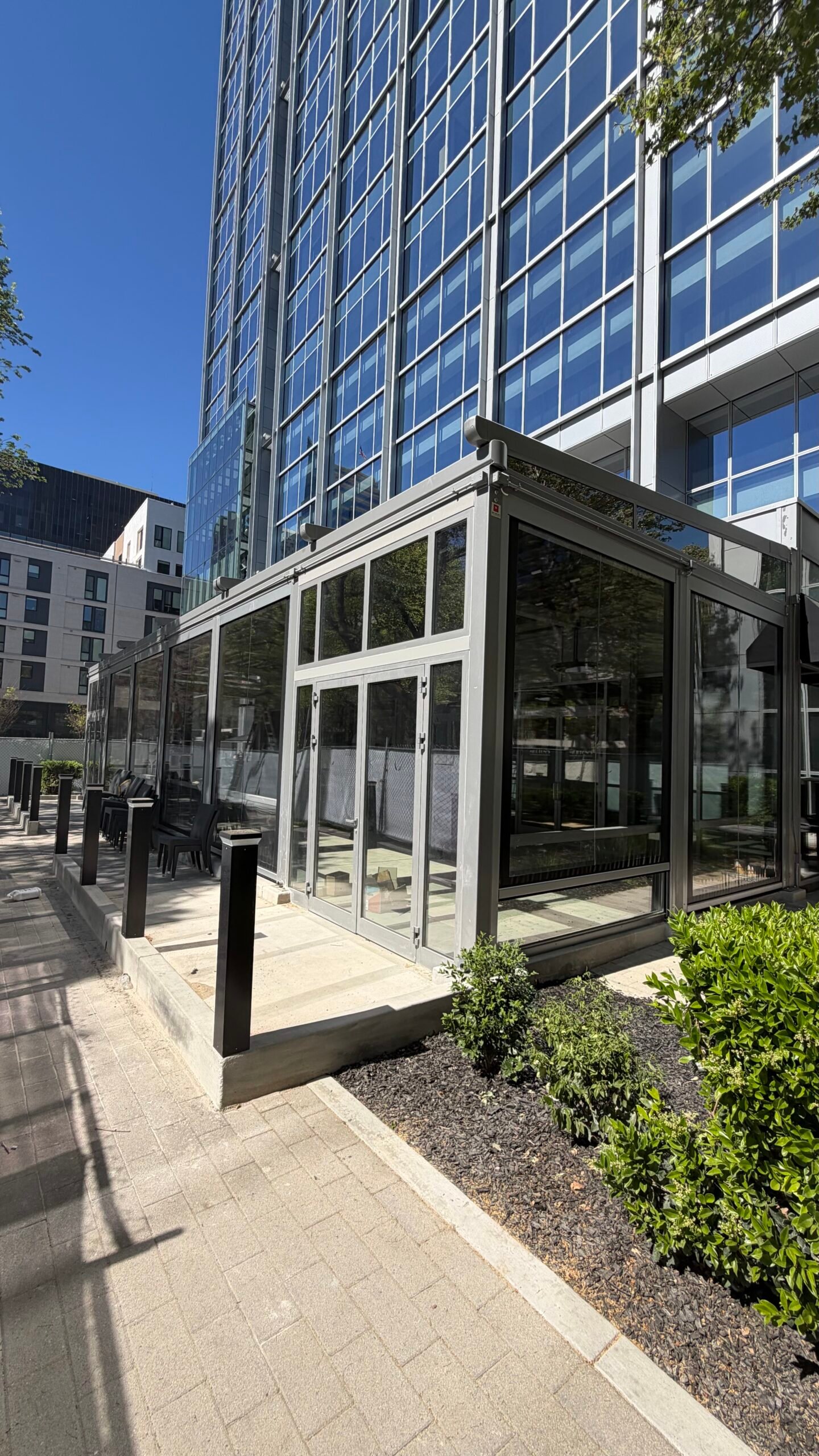 Glass and screen enclosure around a restaurant patio